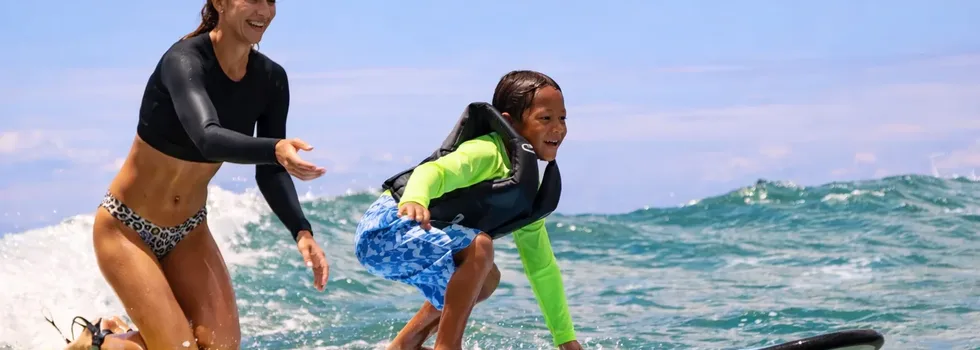 Kid learning to surf in hawaii