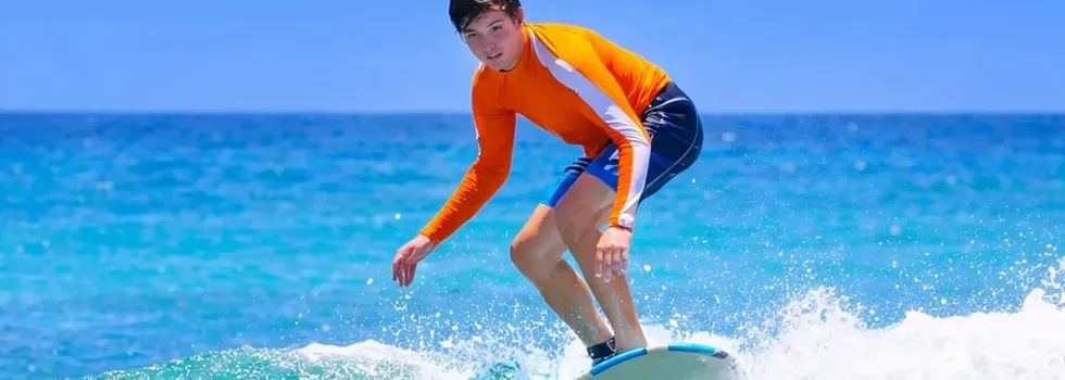 First time surfer rides a wave