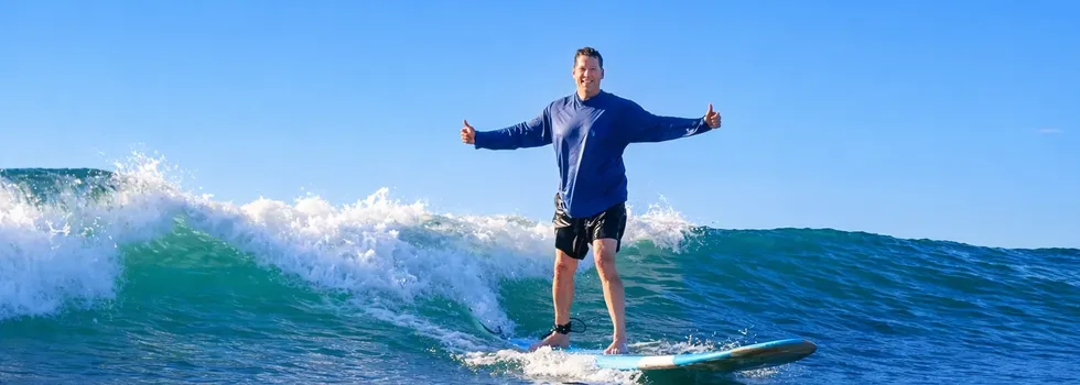 Happy big man surfing