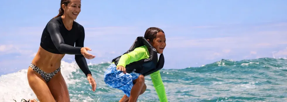 Kid learning to surf in hawaii