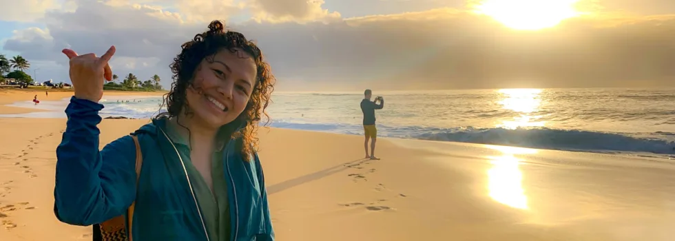 Sandy beach oahu sunrise woman shaka
