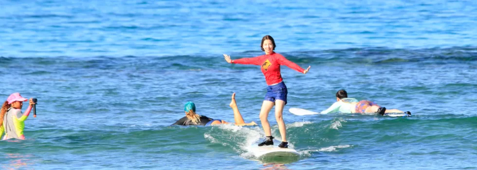 Child catching first wave surfing