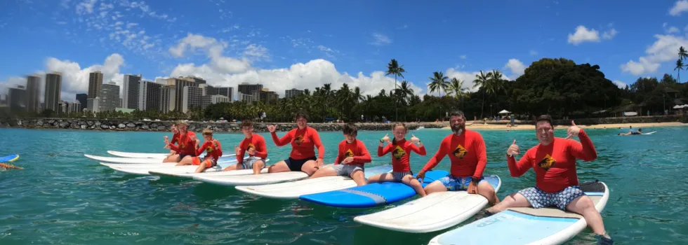 Family portrait sitting on waikiki surfboards
