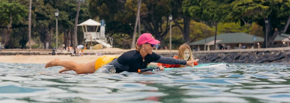 Paddling out to surf break with teacher