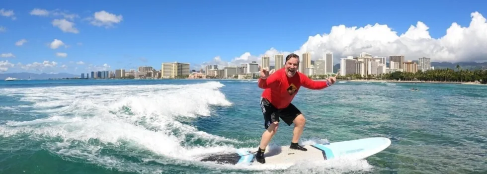 Stoked man surfing waikiki