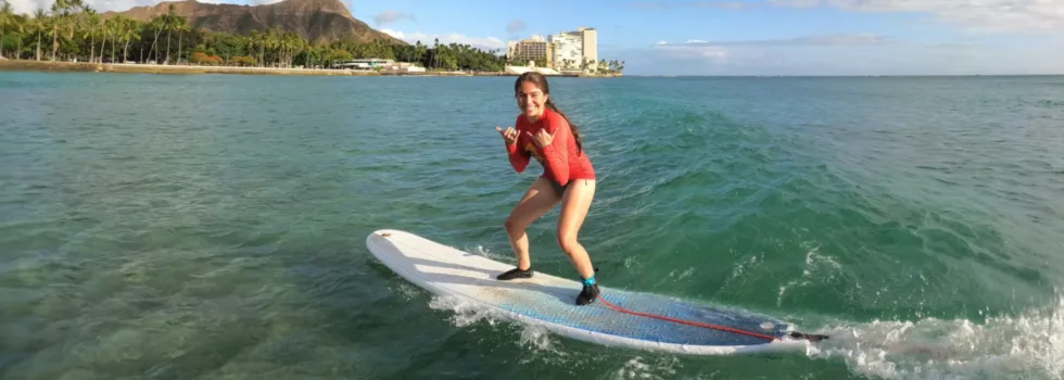 Teenage riding surf lesson wave waikiki