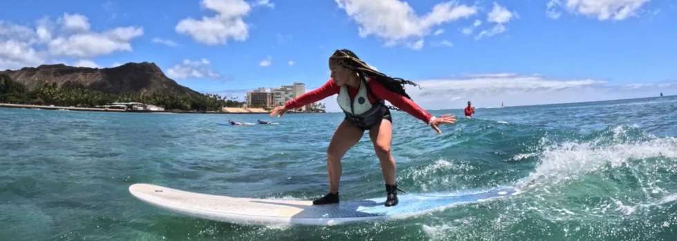 Woman riding wave in waikiki