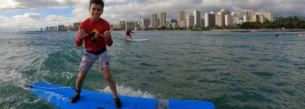 Young boy shaka surf lesson