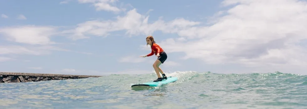 Young boy surfing waikiki