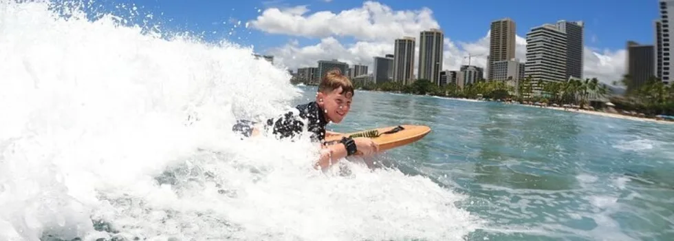 Happy kid body board lesson waikiki