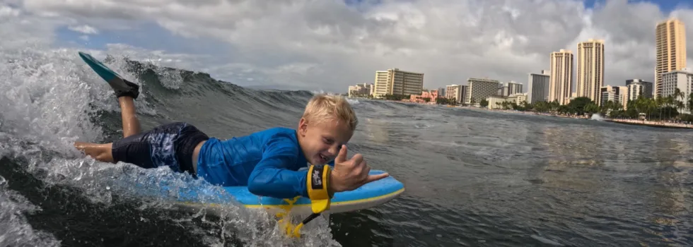 Little boy bodyboarding waikiki