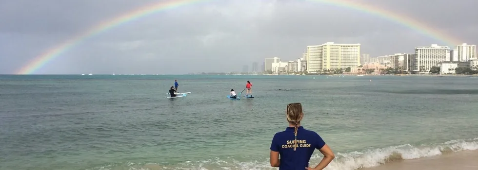 Stand up paddling under a rainbow waikiki
