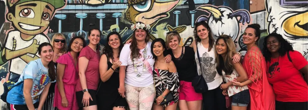 Party bike group in front of mural