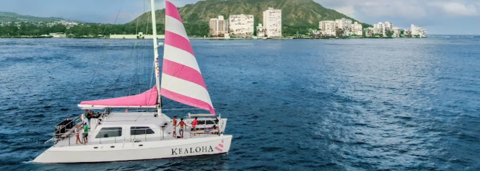 Catamaran sailing past diamond head