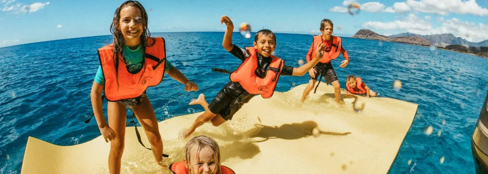 Kids jumping on floating mat honolulu