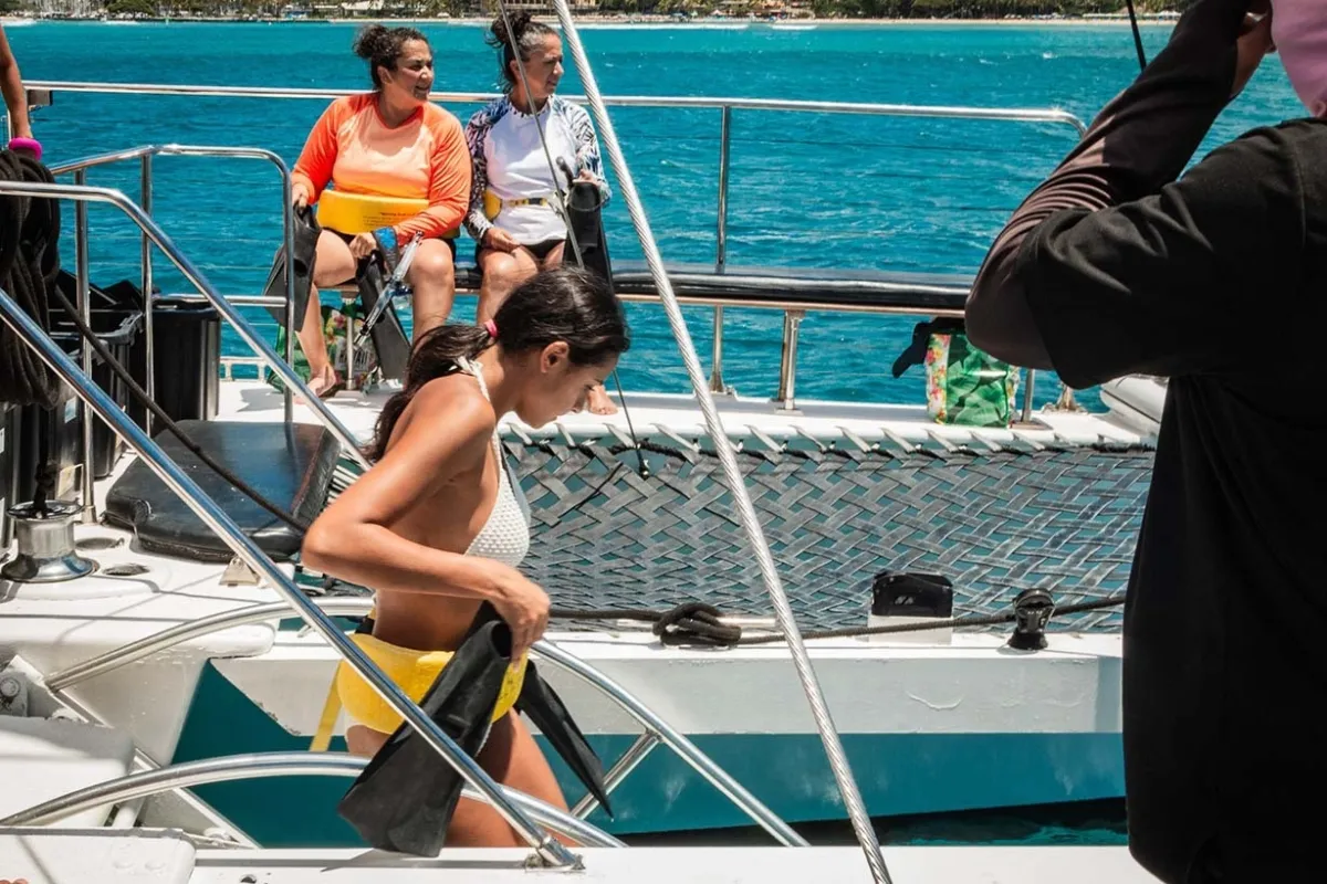 Group snorkeling in calm turquoise waters off Waikiki beach Oahu