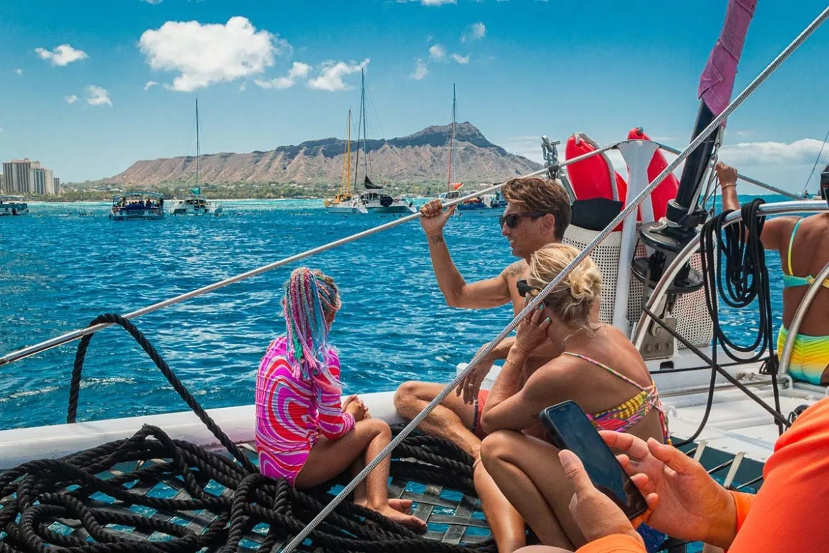 Family enjoying Waikiki snorkel excursion with views of Honolulu skyline